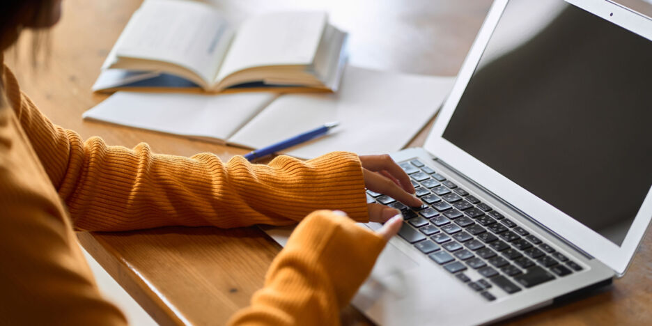 Asian woman's hand studying for qualifications